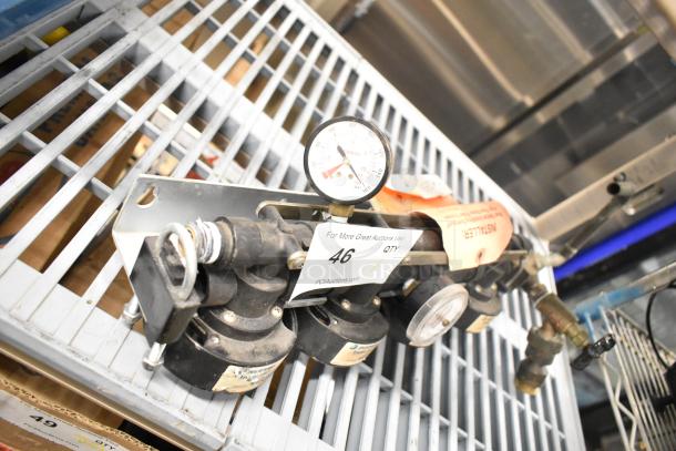 Everpure InsurIce 4000 Water Filtration System, featuring gauges and mounting hardware, shown on metal shelf in used condition.