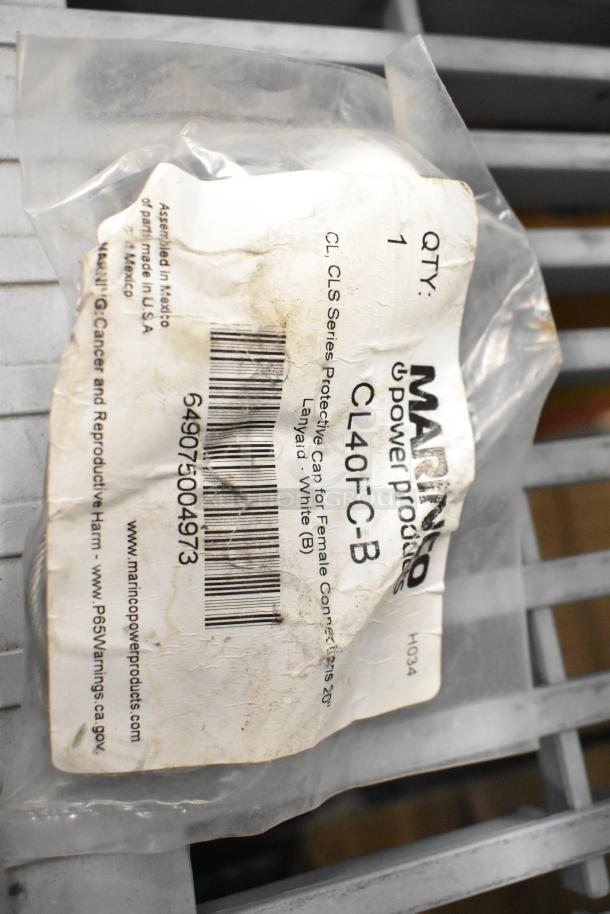 Plastic bag with a label showing "Marinco Power Products," model CL40FC-B, for protective cap; worn appearance.