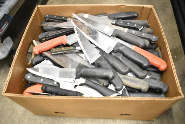 Box of 80 sharpened stainless steel knives, including chef knives, with black and red handles, mixed condition.