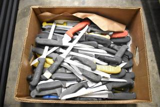 Box of 80 sharpened stainless steel knives, various colored handles, includes serrated knives, used condition.