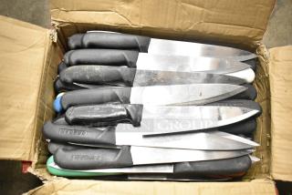 Cardboard box containing 50 sharpened stainless steel knives with black handles, including chef knives; some handles marked "CREBAN."