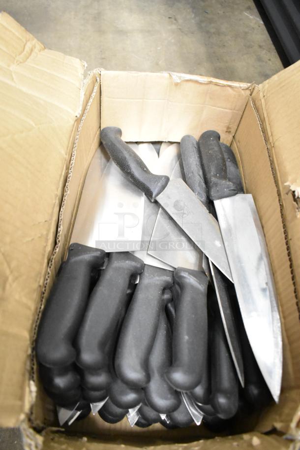 Box of 50 sharpened stainless steel knives, including chef knives, with black handles for auction.