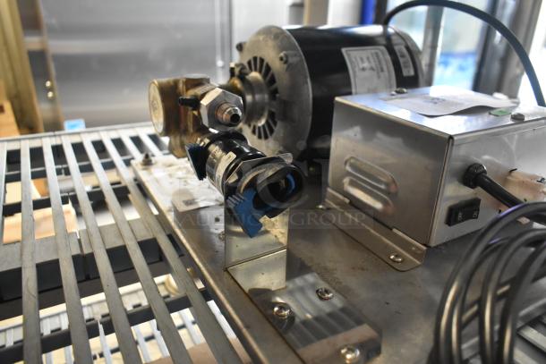 2022 Lancer Carbonator, 115 Volts, 1 Phase, mounted on metal platform. Visible switches and wiring. Excellent condition.