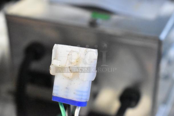 2022 Lancer Carbonator, 115 Volts, 1 Phase. Close-up of a cable connector, slightly worn, showing electrical detail.