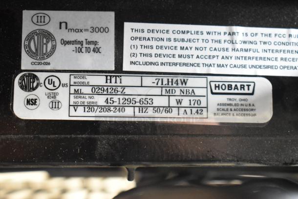 2024 Hobart HTi-7LH4W commercial food scale label, shows model, voltage, serial number, and compliance details.