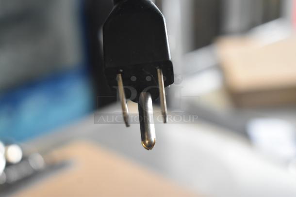 Close-up image of a power plug for the 2017 Hobart HTi-7LH26 Commercial Scale, visible prongs and black casing.