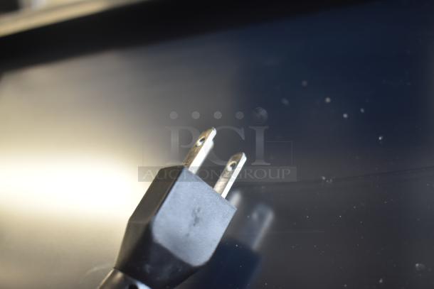 Close-up of the power plug for a 2017 Hobart HTi-7LH26 commercial countertop food portioning scale.