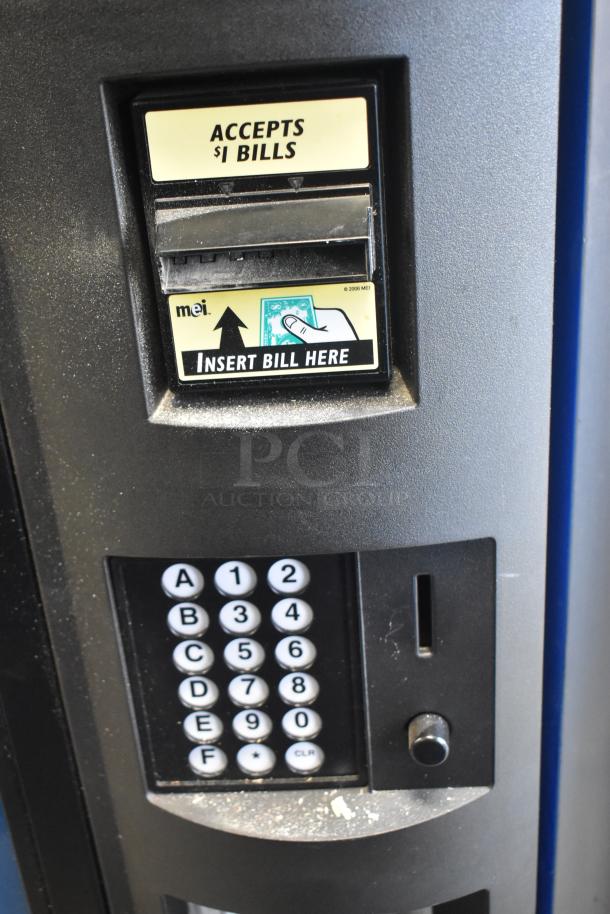 Crane 5800-4 metal vending machine, bill acceptor for $1 bills, keypad, 115V, 1 phase, commercial use, good condition.