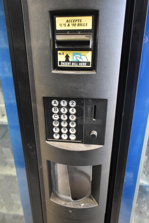 Crane 5800-4 vending machine with bill acceptor, keypad, and slots. Accepts $1, $5, and $10 bills. 115 volts, 1 phase.