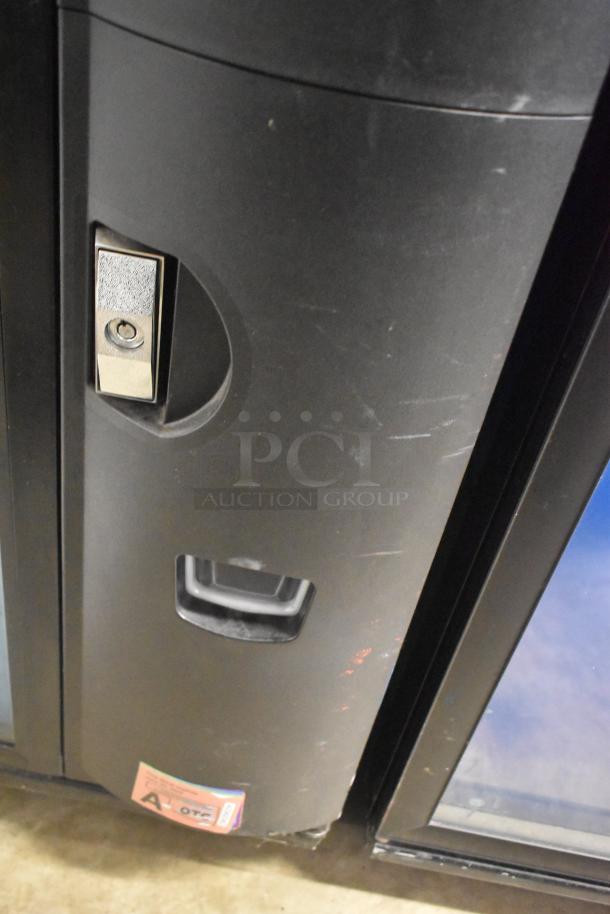 Crane 5800-4 metal drink vending machine with bill acceptor, shows lock and handling area. Some surface wear visible.