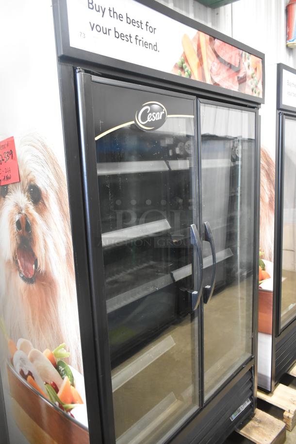 2021 True TVM-48SL-HC commercial 2-door cooler merchandiser, glass doors, branding decals, 115V, 1 phase, used condition.