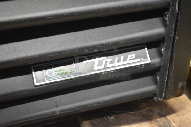 2021 True TVM-48SL-HC 2 Door Reach-In Cooler Merchandiser, showcasing "True" logo and natural refrigerant label.