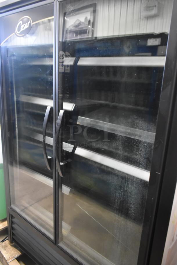 2021 True TVM-48SL-HC commercial 2-door cooler merchandiser, 115 volts, 1 phase. Glass doors, black frame, used condition.