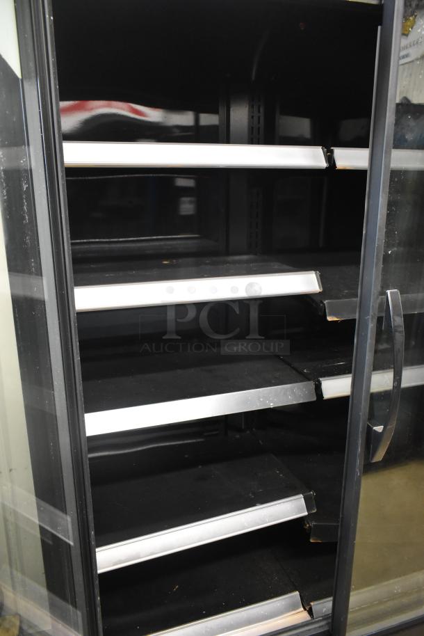2021 True TVM-48SL-HC cooler, 2-door, commercial merchandiser, black interior, multiple shelves, 115 volts, 1 phase.