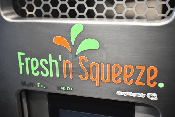 LATE MODEL JBT Fresh N Squeeze citrus juicer, commercial floor style, on casters, 115 Volts, visible branding.