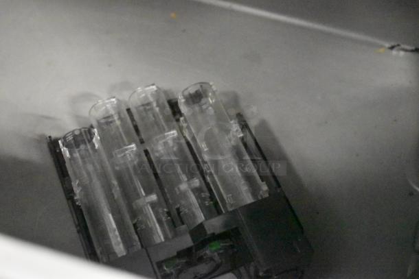 LATE MODEL JBT 2ND-GEN-MFJ-HE citrus juicer component including clear tubes and base, part of commercial juicer.