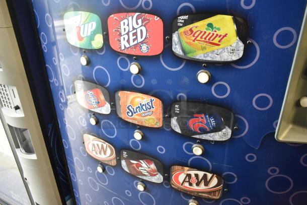 Metal commercial vending machine with bill acceptor, featuring brands like 7UP and A&W. 115 volts, 1 phase power.