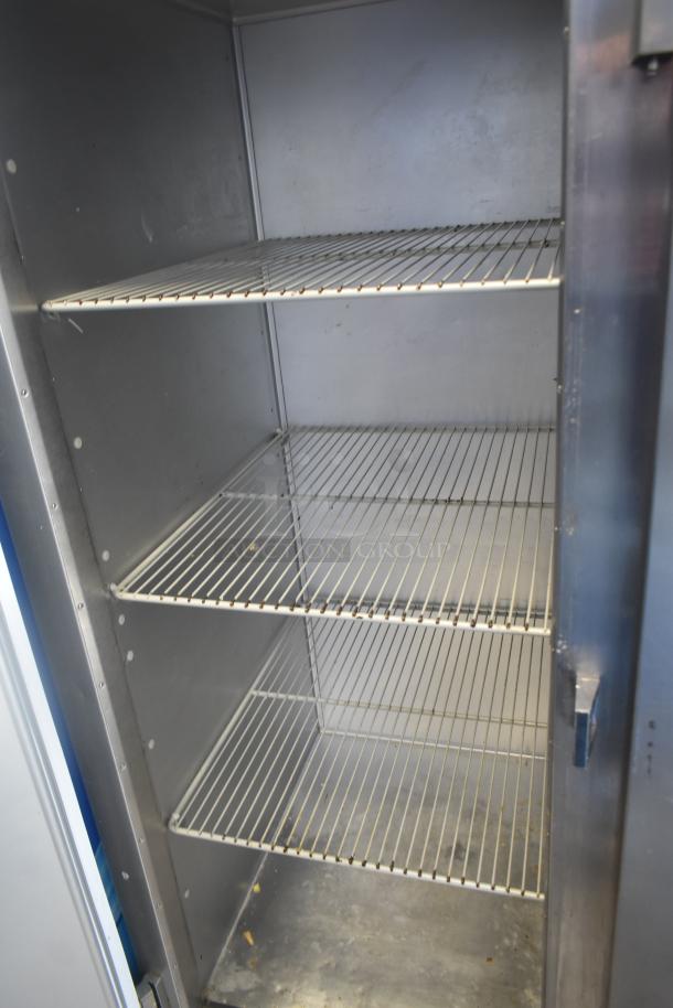 Traulsen G30013 Commercial 3 Door Reach In Cooler, stainless steel interior, three shelves, 115V, 1 Phase, used condition.