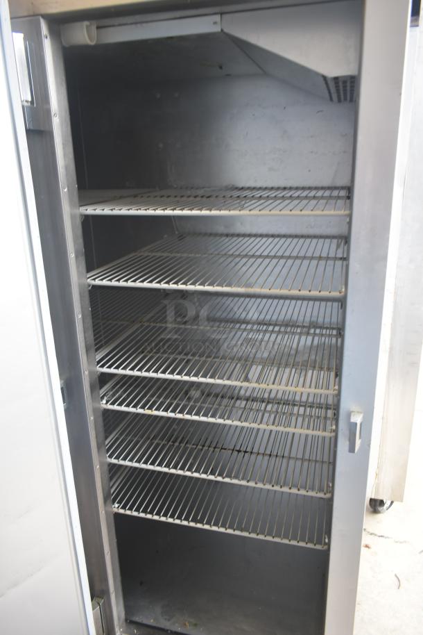 Traulsen G30013 commercial 3-door reach-in cooler, stainless steel, shown open with multiple wire shelves, 115V, 1 phase.
