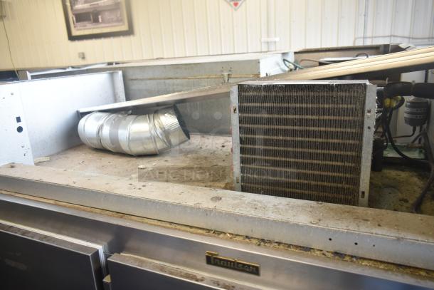 Traulsen G30013 commercial 3-door reach-in cooler, stainless steel exterior, shows signs of use, 115V, 1 phase.