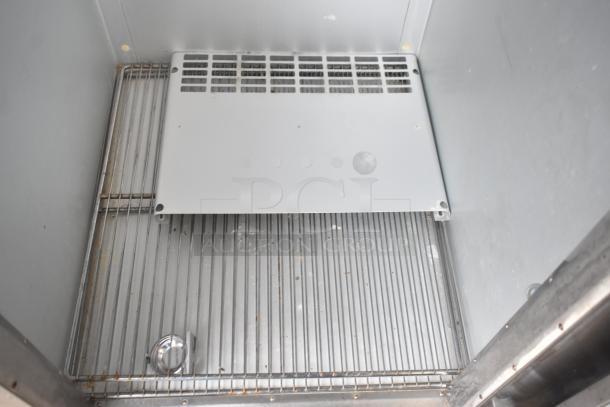 Traulsen ALT132WUT-FHS commercial freezer, interior view, steel racks, clean condition, on commercial casters. 115V, 1 phase.