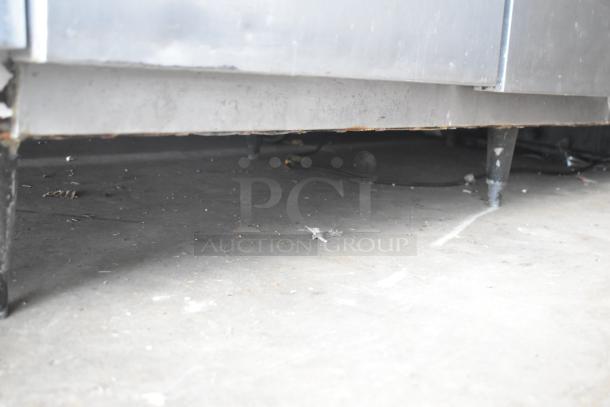 McCall 4-4070 Commercial 3-Door Reach-In Cooler, 115V, 1 Phase, shown in worn condition, emphasizing lower section.