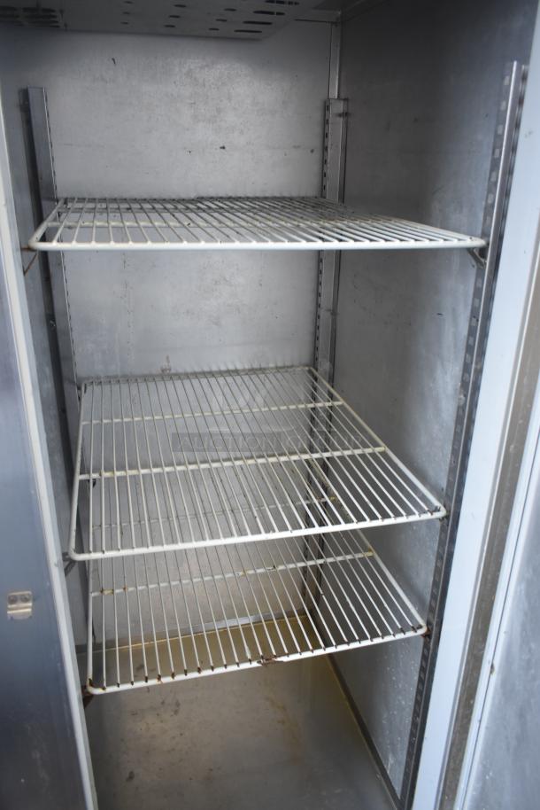 McCall 4-4070 commercial 3-door reach-in cooler, features adjustable wire shelving, 115 volts, 1 phase, gray interior.