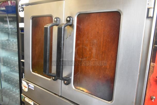 Two Vulcan VC5GD-11D1Z convection ovens with view-through doors and thermostatic controls on commercial casters.