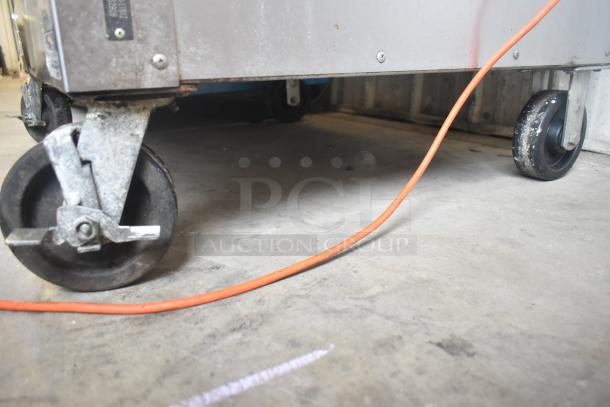 Vulcan VC5GD-11D1Z commercial oven on commercial casters, visible wear, orange power cord.