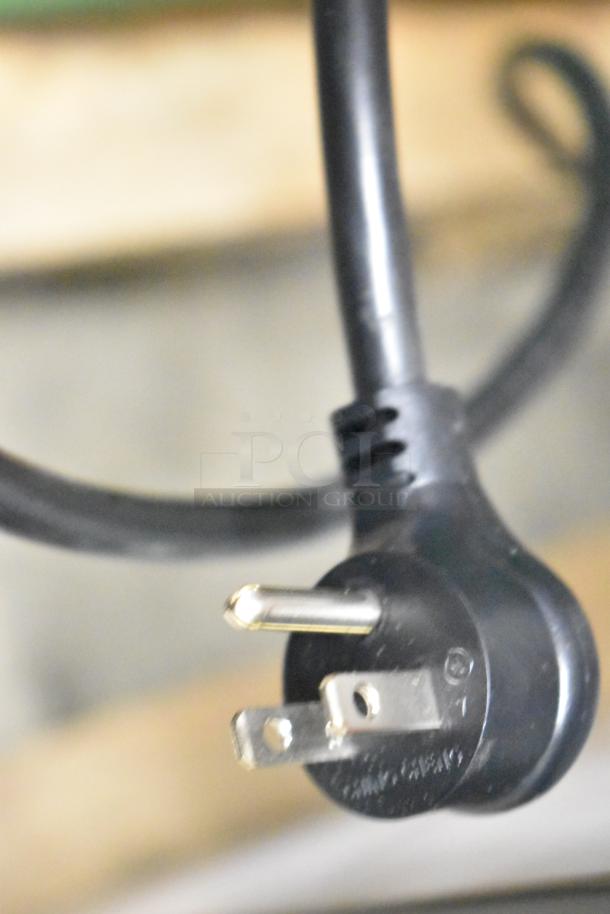 Close-up of a power plug for the True TVM-48SL-HC Commercial Cooler, featuring a black 115-volt, 1-phase connection.