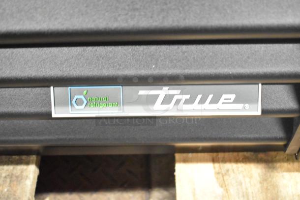 BRAND NEW True TVM-48SL-HC 2 Door Cooler Merchandiser with "natural refrigerant" label.
