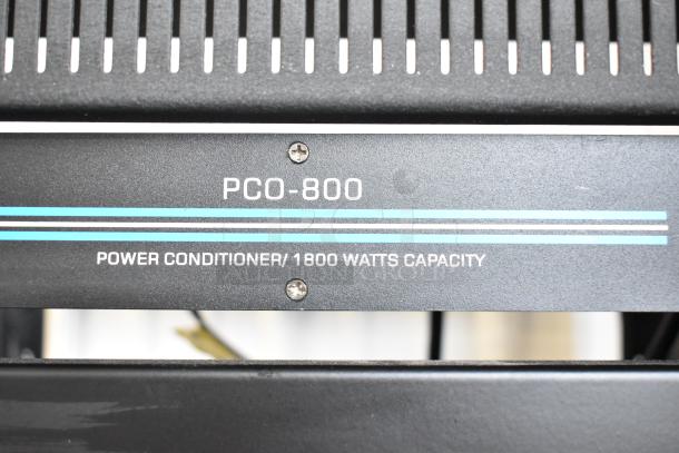 Close-up of a Pyle PCO-800 Power Conditioner with 1800 watts capacity, showing front panel and horizontal vents.