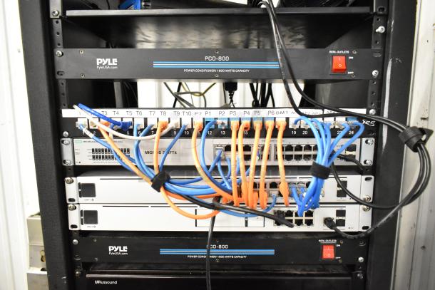 AV cabinet with Pyle PCI-800 and PCO-800 power conditioners, HPE OfficeConnect switch, network cables, and rack units.