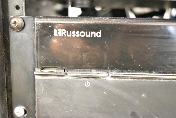Russound MCA-88 Multizone Controller Amplifier in black. Visible power button, slight wear on the panel.
