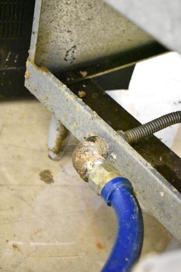2023 Pitco Frialator 40D natural gas fryer component, showing a blue gas line connection. Visible wear on fittings.