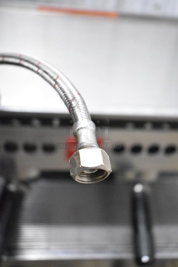 Torrie MTE225XC70 espresso machine detail; features dual portafilters, steam wands visible, commercial grade.