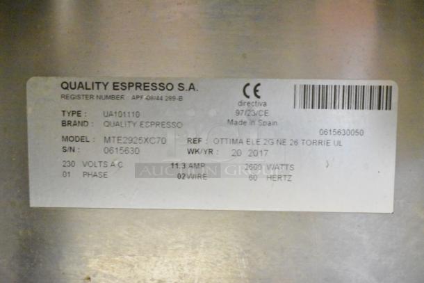 Close-up of a label on the Torrie MTE225XC70 commercial espresso machine, detailing model and specifications.