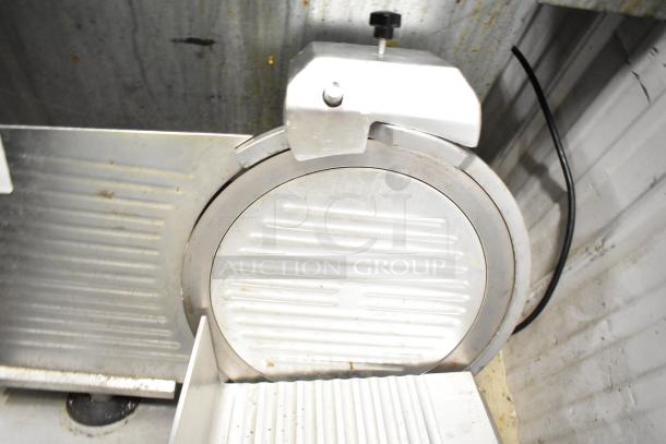 Avantco 177SL312 commercial meat slicer with blade sharpener, silver metal, countertop model, 115V, visible wear.