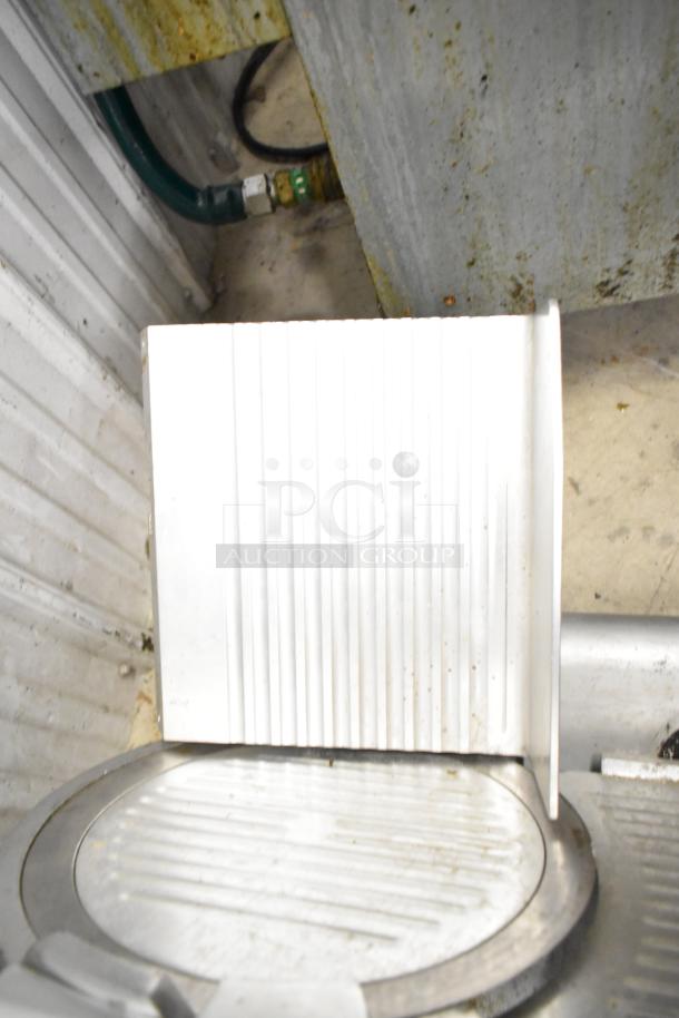 Avantco 177SL312 commercial meat slicer with blade sharpener, countertop model, 115 volts, visible wear, stainless steel finish.