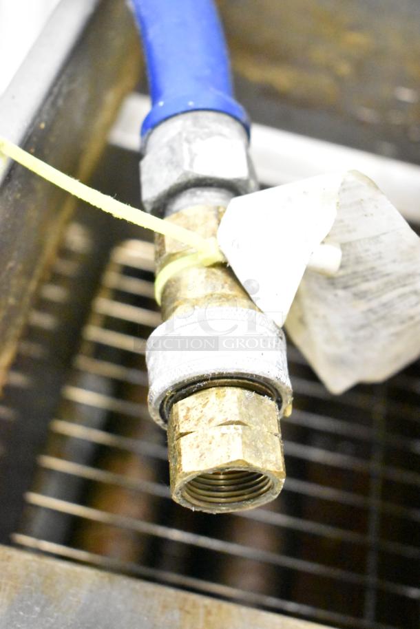 Close-up of Pitco Frialator 40D fryer gas connection. Includes blue hose and identification tag. Used condition.