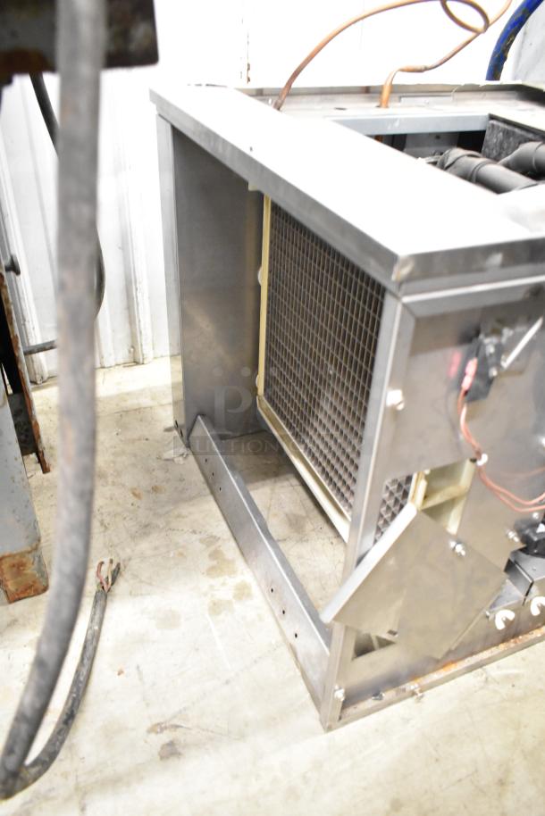 2021 Ice-O-Matic ICE1506HT2 commercial ice head, 208-230V, 1 phase, shown in used condition with visible wiring and metal framework.