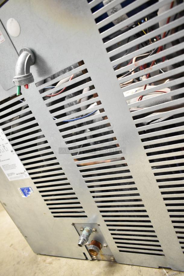 2021 Ice-O-Matic ICE1506HT2 commercial ice head, 208-230 volts, 1 phase. Metal exterior with vents.