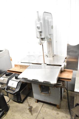 Hobart commercial floor meat saw, industrial-grade, metal construction, visible rust on base, used condition.