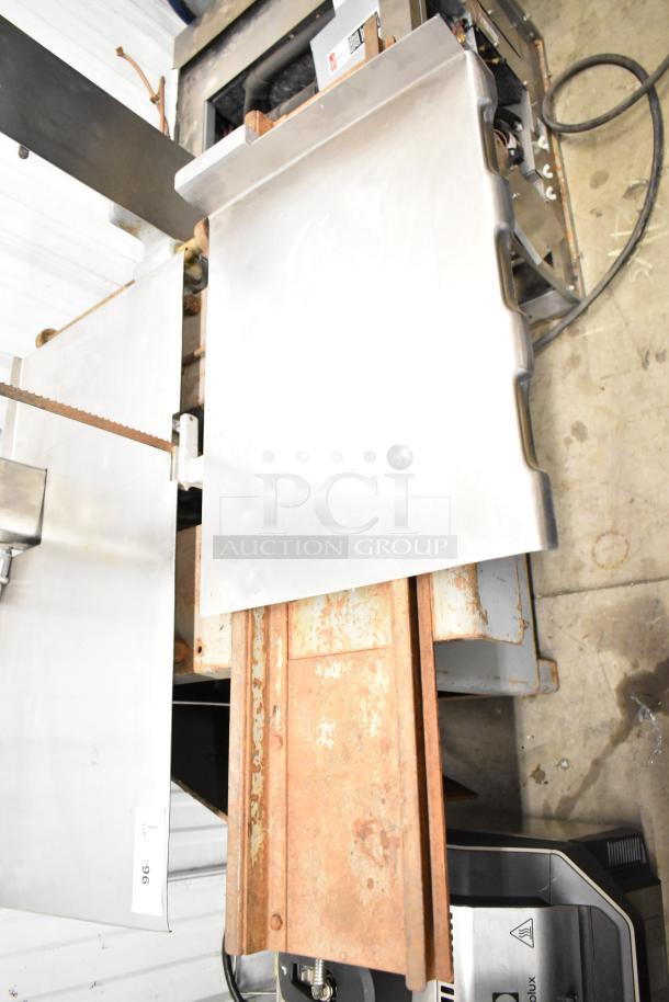 Hobart Commercial Floor Style Meat Saw, metallic body, rust on base tray, visible electric cord, industrial use, in used condition.