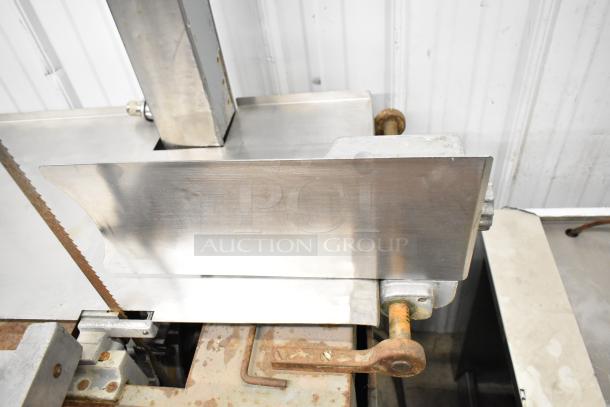 Hobart commercial floor-style meat saw, metal construction, visible blade, signs of rust, used condition.
