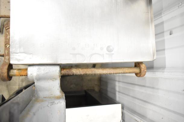 Hobart Commercial Floor Style Meat Saw, showing rusted metal parts and numbered gauge markings, in used condition.