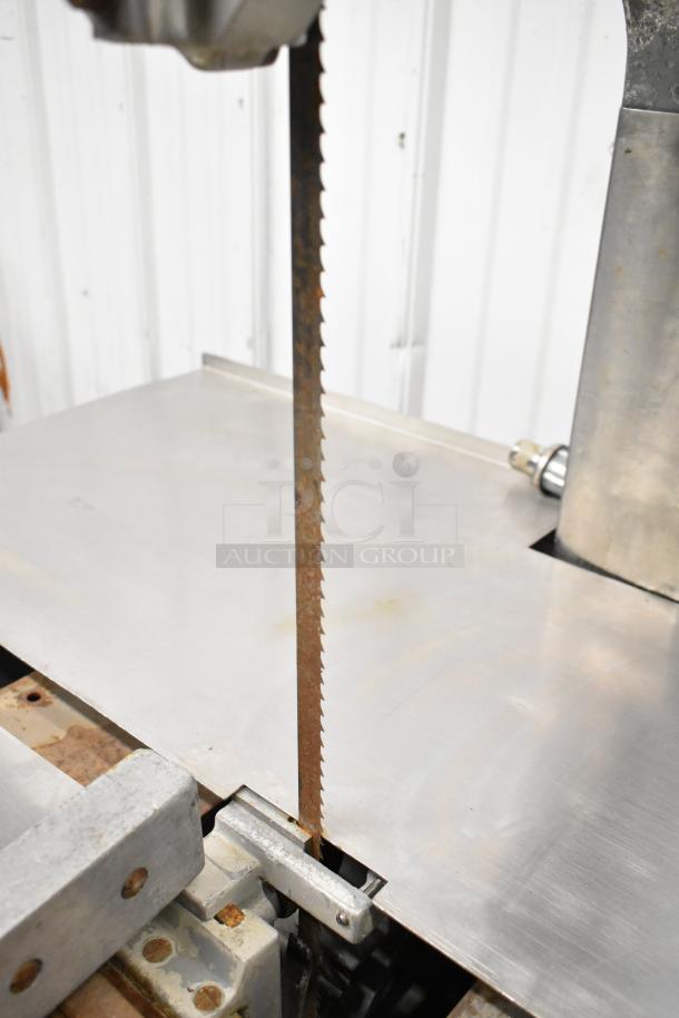 Hobart Commercial Floor Style Meat Saw with a metal cutting table and visible blade, showing some rust.