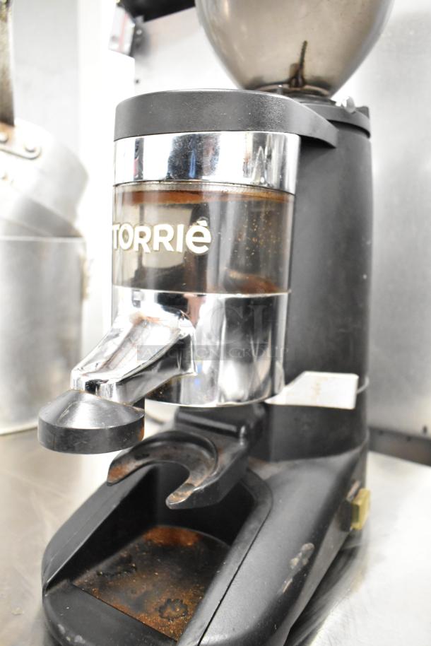 2017 Torrie Moinho D64-E-PR-D espresso grinder, black, chrome accents, visible wear, 115V, 1 Phase, commercial use.