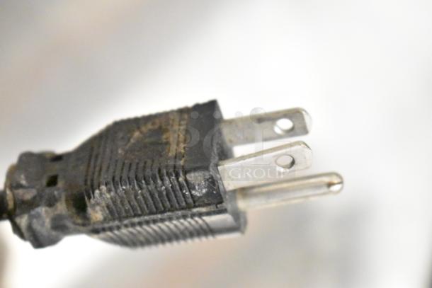 Close-up shot of a power plug end for a 2017 Torrie Moinho D64-E-PR-D Espresso Bean Grinder, showing wear.