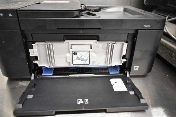 Canon K10546 multifunction printer, model TR4720, with open paper tray. Black exterior, appears in good condition.